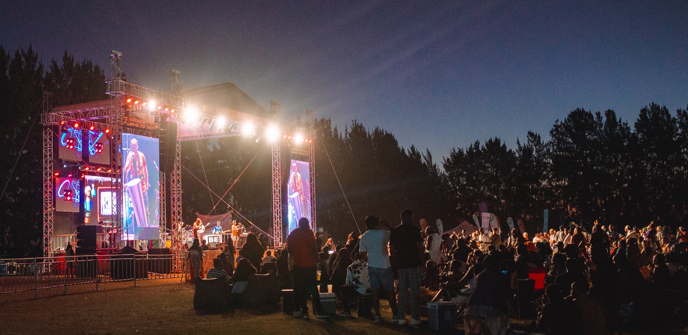 Audience watching the illuminated Jacaranda Music Festival stage
